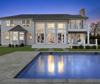 Elegant two-story home at dusk with a pool, exterior freshly painted
